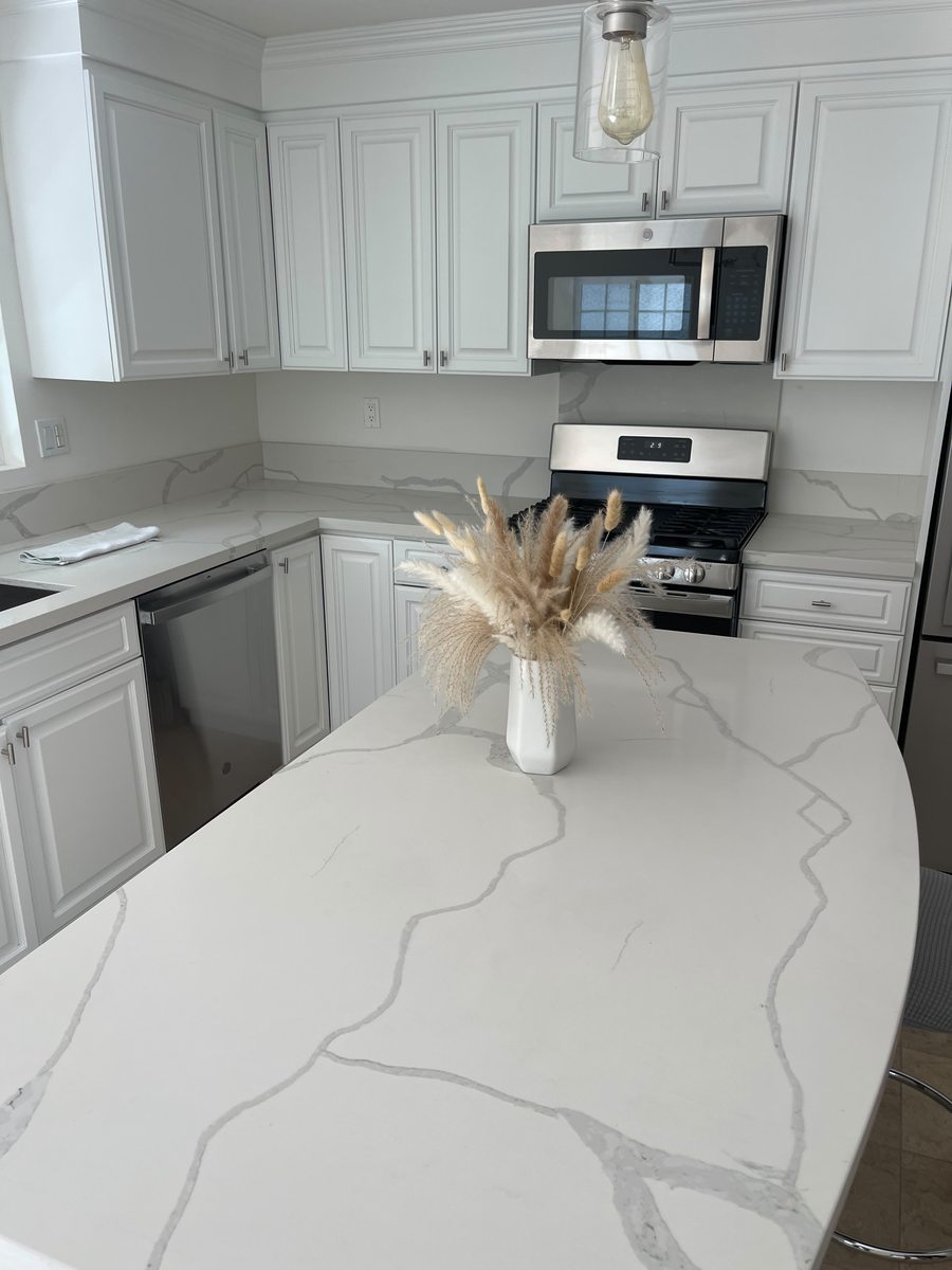 Modern kitchen remodel with quartz waterfall island